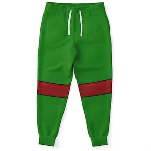 May include: Green sweatpants with a red band across the knees and a white drawstring. The trousers are made of a soft material and are designed for comfort and casual wear.
