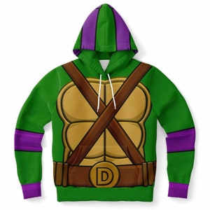 May include: Green hooded sweatshirt with a purple hood and sleeves. The front of the sweatshirt features a cartoon image of a turtle shell with a brown belt and a gold buckle with the letter "D".