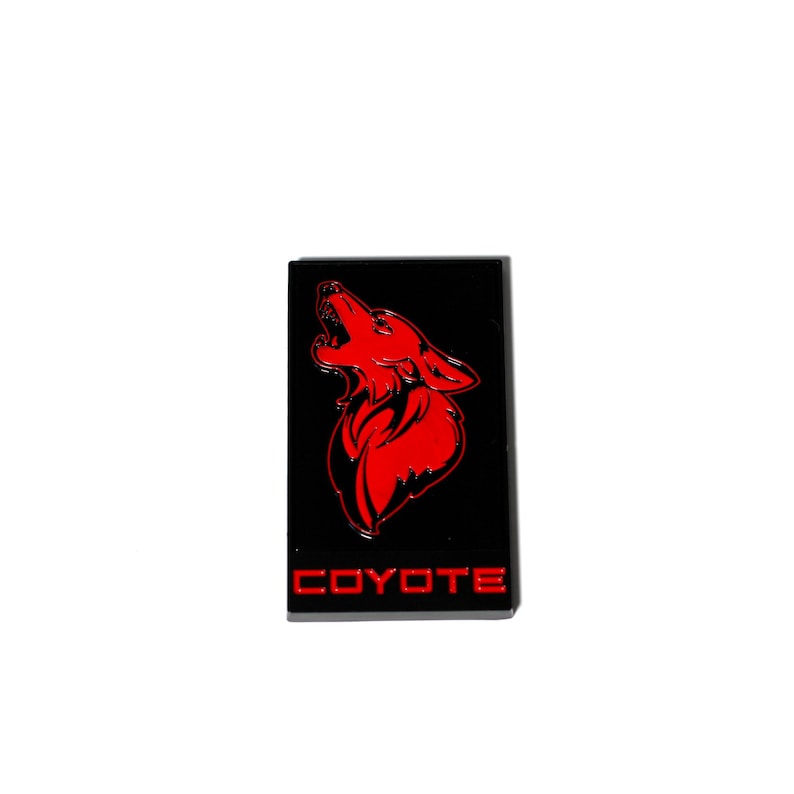 May include: Red and black emblem with a howling coyote silhouette and the word "COYOTE" in red lettering.