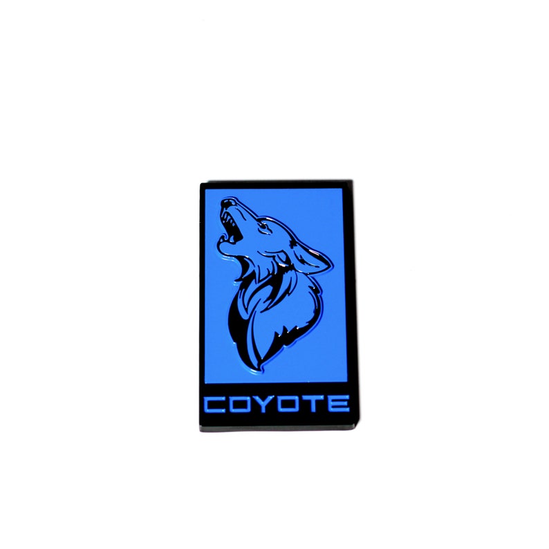 May include: A black and blue emblem with a howling coyote silhouette and the word "COYOTE" in white lettering.