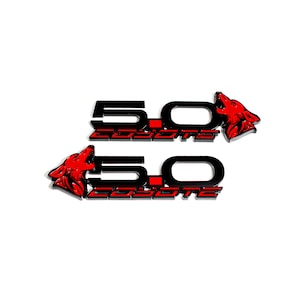 May include: Two black and red 5.0 Coyote emblems with a wolf head design.