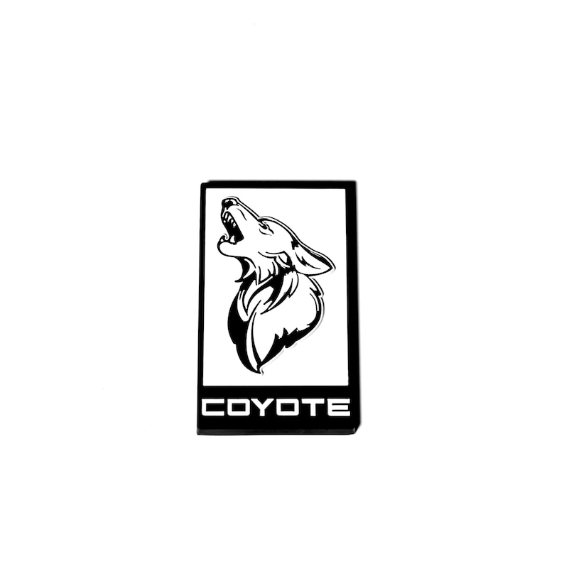 May include: Black and white emblem with a howling coyote silhouette and the word "COYOTE" in white text on a black background.