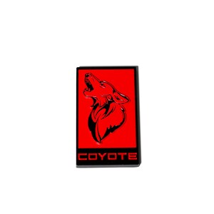 May include: Red and black emblem with a howling coyote silhouette and the word "COYOTE" in red letters.