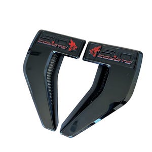 May include: A set of three ceramic mugs with a speckled, matte finish. The mugs are in shades of cream, light gray, and dark gray. Each mug has a simple, minimalist design and a rounded handle.