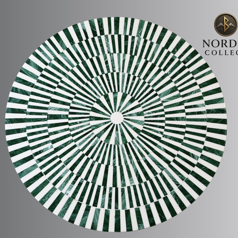 May include: Circular table top with a geometric pattern of alternating green and white stripes radiating from the center. The design creates a visual effect, resembling a target or a sunburst. The table top is likely made of stone or a similar material.