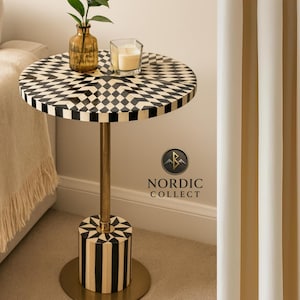 May include: A set of three ceramic mugs with a speckled, cream-colored glaze. Each mug features a different hand-painted floral design in shades of blue, green, and yellow. The mugs have a simple, rounded shape and a comfortable handle.