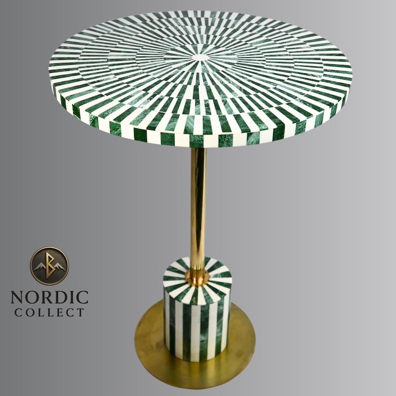May include: A round side table with a green and white striped top. The table has a gold-colored metal stem and base. The base is cylindrical with matching green and white stripes. The table is approximately 24 inches tall.