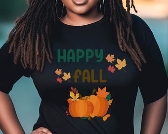 Könnte beinhalten: Schwarzes T-Shirt mit dem Text "Happy Fall" in grünen und orangen Buchstaben, umgeben von orangen und braunen Blättern. Zwei orangefarbene Kürbisse mit grünen Stielen und Blättern befinden sich unter dem Text.