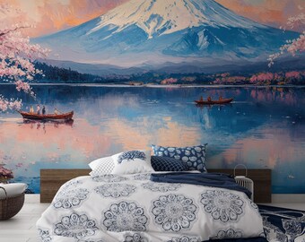 May include: A white bed with a blue and white patterned duvet cover and blue pillows. The bed is in front of a wall mural depicting Mount Fuji, a lake, and cherry blossoms.