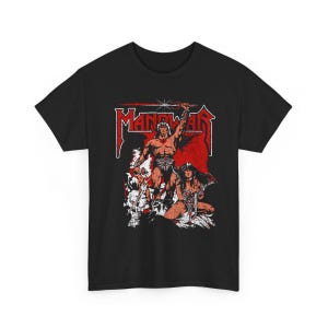 May include: Black t-shirt featuring a red and white graphic of a muscular warrior holding a sword, with a woman and the word "MANOWAR" in a stylized font. The design has a vintage, comic book style.