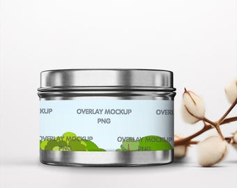 May include: Silver metal container with a white label that says "Overlay Mockup PNG". The label has a green and blue illustration of trees and a sky.