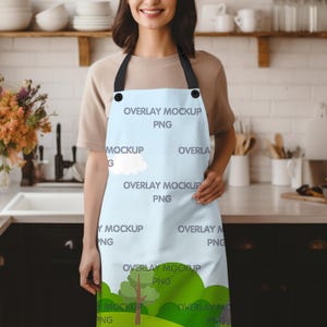 May include: A light blue apron with a white cloud design and the text "OVERLAY MOCKUP PNG" repeated throughout. The apron has black adjustable straps and black metal buckles.