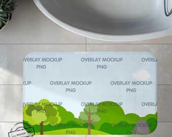 May include: A blue and green bath mat with a cartoon landscape design. The mat has the text "Overlay Mockup PNG" repeated throughout the design.