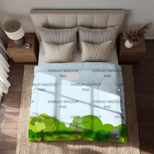 May include: A bed with a light blue blanket featuring a green landscape design with trees and clouds. The blanket is labeled with the text "OVERLAY MOCKUP PNG". The bed has beige pillows and a beige headboard. A lamp and a vase are on the nightstands.