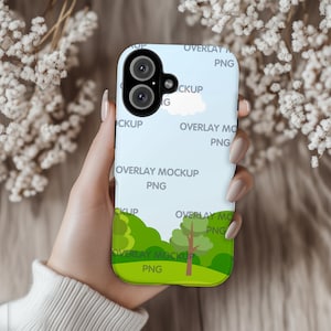 May include: A phone case with a landscape design featuring green trees, a blue sky, and a white cloud. The case has a light blue background and the text "OVERLAY MOCKUP PNG".