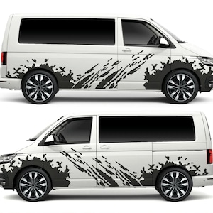 May include: A white van with black mud-splatter graphics on the sides. The van has black wheels with silver spokes.