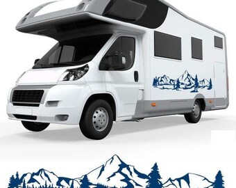 May include: A white camper van with a blue mountain range decal on the side. The decal features a stylized mountain range with trees and a river.