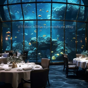 May include: A dining room with white tablecloths and chairs, set with silverware and glasses. A large aquarium with blue water and yellow fish is visible in the background. The text '@VideoCallBackgrounds on Etsy' is visible in the lower right corner of the image.