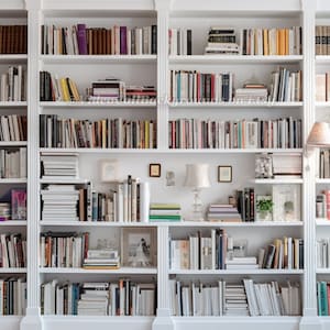 May include: A white bookshelf with multiple shelves filled with books. The bookshelf is divided into three sections, each with a different arrangement of books.