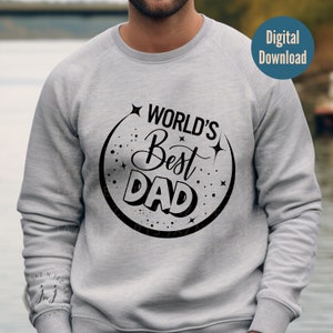 Könnte beinhalten: Ein graues Sweatshirt mit einem schwarzen Kreisdesign, auf dem in einer Retro-Schrift "World's Best Dad" steht.