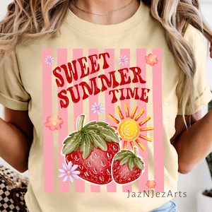 May include: A light yellow t-shirt with a graphic design featuring the text "Sweet Summer Time" in red, along with pink stripes, strawberries, a sun, and flowers. The design is centered on the shirt.