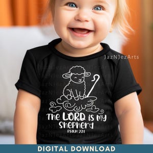 May include: A black baby bodysuit with a white graphic of a sheep, shepherd's staff, and the text "The LORD is my Shepherd, Psalm 23:1." The words "DIGITAL DOWNLOAD" are at the bottom.