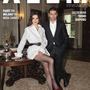 May include: Magazine cover with the title "ALEM" in white. The cover features Sinem Ünsal and Ozan Akbaba. Text includes "PARIS'TEN MILANO'YA MODA SAHNESI" and "GASTRONOMI TREND RAPORU". The cover also has the text "MİDYAT TA HAYALLERE UZANAN YOLCULUK".