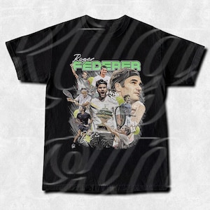May include: Black t-shirt featuring a collage of images of Roger Federer, tennis balls, and the text "Roger Federer". The design includes various action shots and a portrait of the tennis star.