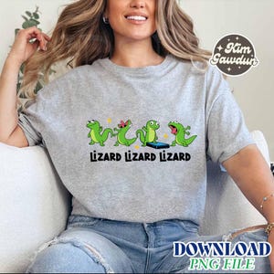 May include: A light gray sweatshirt featuring a graphic of four green cartoon lizards with the word "Lizard" below each lizard. The lizards are in different poses, with one holding a phone. The text "DOWNLOAD PNG FILE" is at the bottom.