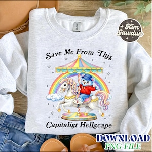 May include: A light gray sweatshirt featuring a carousel design with a bear riding a unicorn, a rainbow, and the text "Save Me From This Capitalist Hellscape." The design includes a carousel with a striped canopy and a bear wearing a red jacket and blue pants.