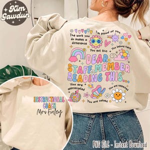 May include: A beige sweatshirt with a colorful graphic design that says "Dear Staff Member Reading This..." with hearts, flowers, and stars. The sweatshirt also has the text "Instructional Coach Mrs. Finley" on the front.