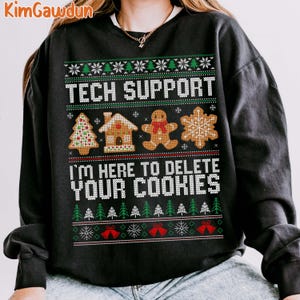 May include: Black Christmas jumper with a white snowflake pattern and the text "Tech Support I'm here to delete your cookies". The jumper features gingerbread cookies, a gingerbread house, and a gingerbread person.