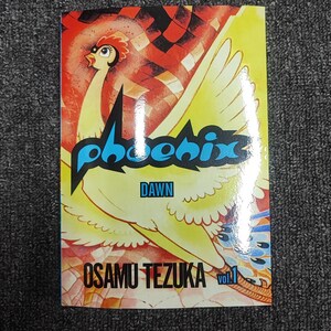 May include: A comic book cover featuring a yellow phoenix with blue text that reads "phoenix" and "dawn". The text "OSAMU TEZUKA" and "vol. 1" are also visible in blue.