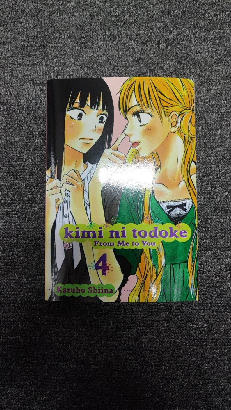 May include: Volume 4 of the manga series "kimi ni todoke: From Me to You" by Karuho Shiina. The cover features two young women, one with black hair and the other with blonde hair, looking at each other.