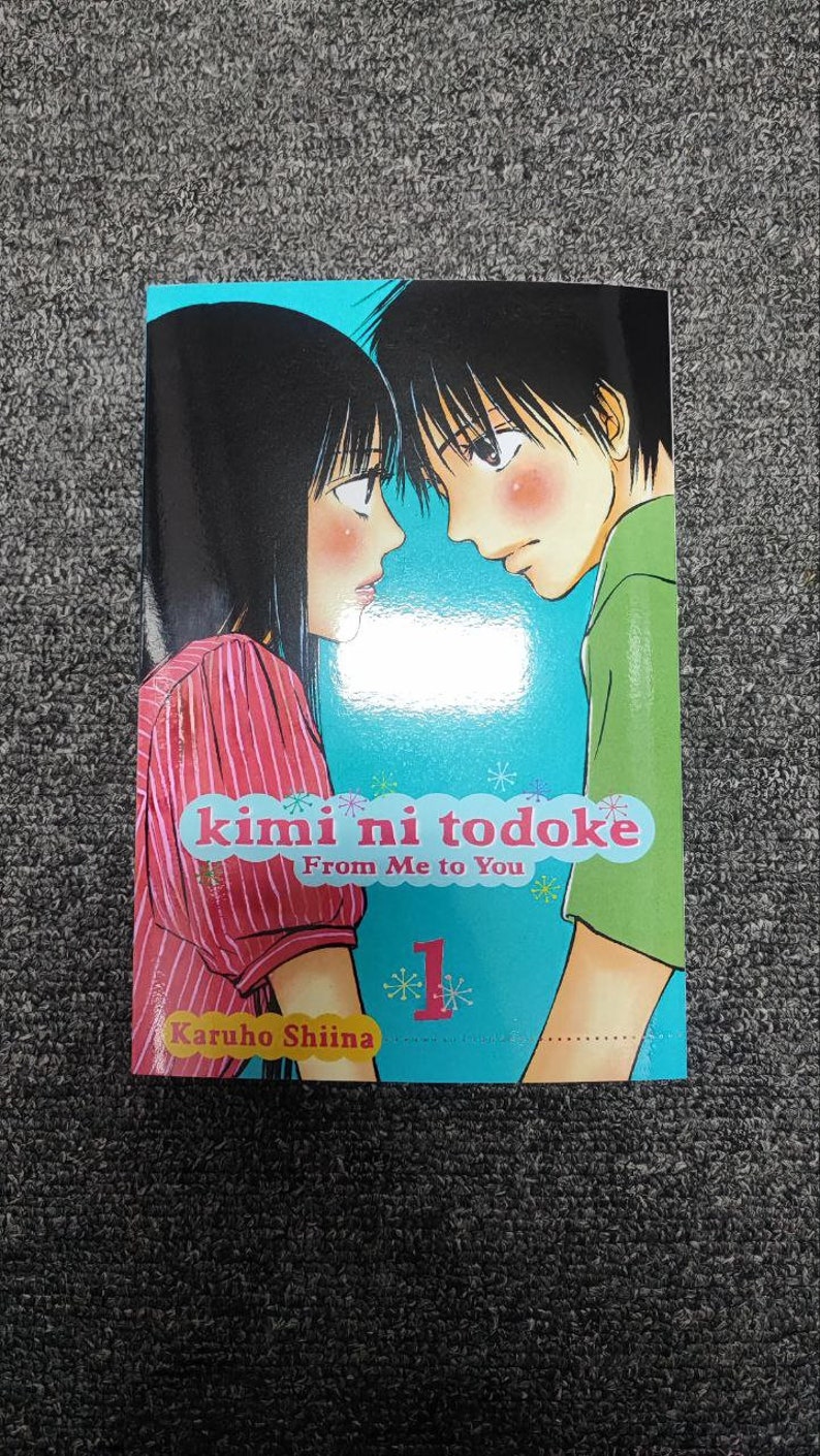 May include: A manga book cover featuring two anime characters, a girl with long black hair and a boy with short black hair. The title of the book is "kimi ni todoke" and the subtitle is "From Me to You". The book is volume 1.
