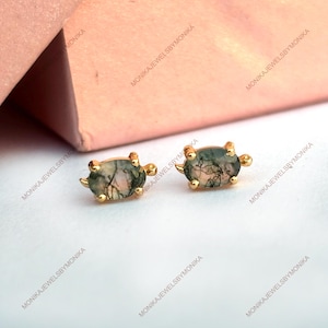 May include: A pair of gold turtle stud earrings with green and white agate stone insets.