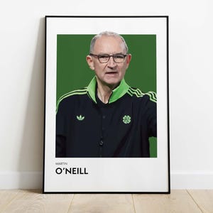 May include: A framed portrait of Martin O'Neill, set against a green backdrop. He wears glasses and a black jacket with green accents and logos. The name "MARTIN O'NEILL" is printed in black at the bottom of the frame.