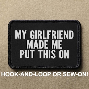 May include: Black patch with white text that reads "MY GIRLFRIEND MADE ME PUT THIS ON". The patch is for hook-and-loop or sew-on attachment.