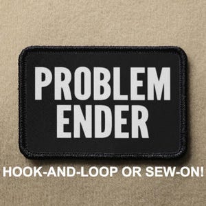 Peut inclure: Patch noir avec du texte blanc qui dit "PROBLEM ENDER". Le patch est conçu pour être fixé par scratch ou cousu.