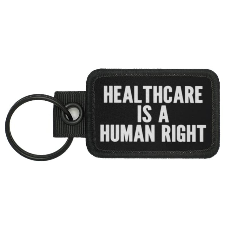 May include: Black key chain with a black rectangular tag that reads "Healthcare is a Human Right" in white text.