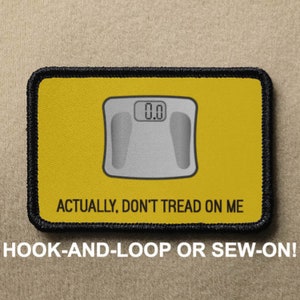 May include: Yellow and black patch with a white scale reading 0.0. The text "ACTUALLY, DON'T TREAD ON ME" is printed below the scale. The patch is for hook-and-loop or sew-on.