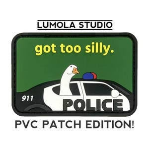 May include: A green and black PVC patch with a white goose in a police car. The text on the patch reads "got too silly." and "Police". The patch also has the number "911" on the car. The text "PVC Patch Edition!" is below the patch.