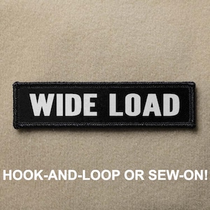 Puede incluir: Parche negro y blanco "WIDE LOAD" con cierre de velcro o para coser.