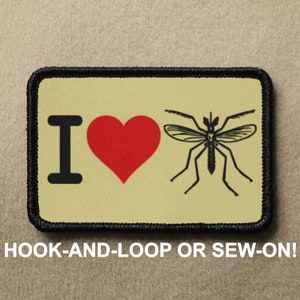 May include: A beige patch with black stitching around the edges. The patch features a black and white illustration of a mosquito with the text "I love" and a red heart.