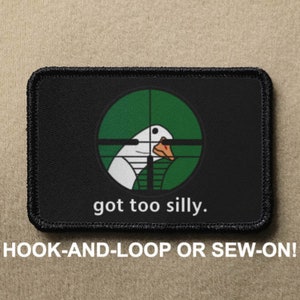 May include: Black and green patch with a white goose in a green target with a red dot. The text "got too silly." is below the target.