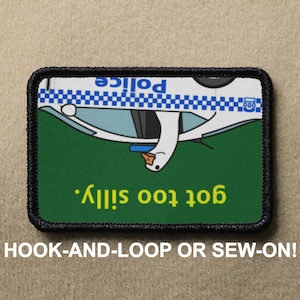 May include: An embroidered patch featuring a cartoon goose driving a police car upside down. The text "got too silly." is written in yellow on the patch. The patch is designed to be sewn or attached with hook and loop.