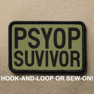 May include: A green and black patch with the text "PSYPOP SURVIVOR" in black lettering. The patch has a black border and is designed to be attached with hook-and-loop or sewn on.