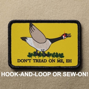 May include: A yellow patch with a black border features a cartoon goose with red eyes and the text "DON'T TREAD ON ME, EH". The patch is for hook-and-loop or sew-on attachment.