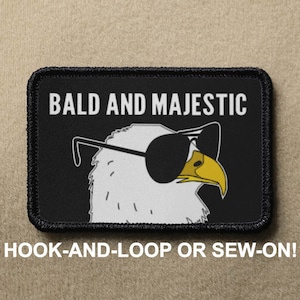 May include: Black patch with white stitching, featuring a bald eagle wearing sunglasses and the text "BALD AND MAJESTIC". The patch is labeled "HOOK-AND-LOOP OR SEW-ON!"