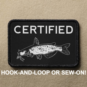 May include: Black patch with white text that reads "CERTIFIED" and a white silhouette of a catfish. The patch has a black border with white stitching. The text "HOOK-AND-LOOP OR SEW-ON!" is printed below the patch.